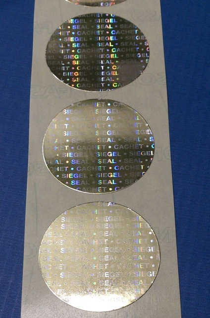 Siegeletiketten aus goldenem Hologrammpapier mit Securtiy-Endlostext