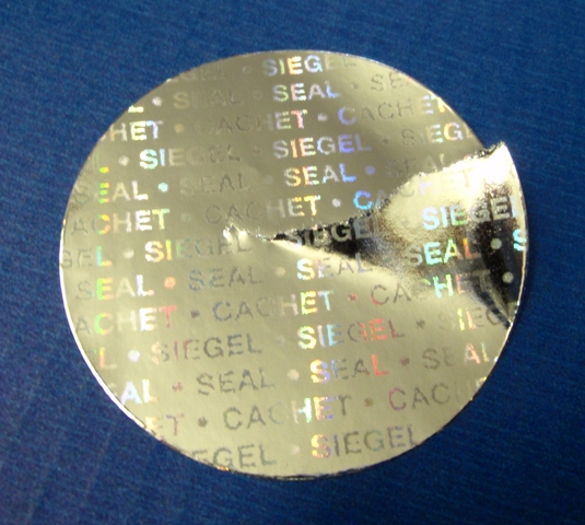 Runde Klebepunkte aus glänzend goldenem Hologrammpapier mit Endlostext Siegel Seal Cachet