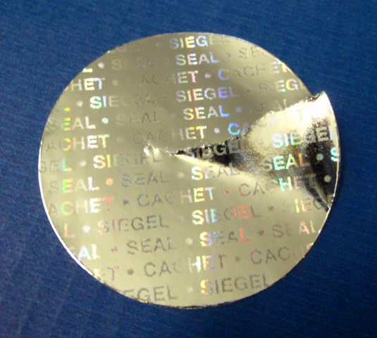 Goldene Hologrammsiegel - das Papier zerreißt bei Ablöseversuchen Runde Klebepunkte aus glänzend goldenem Hologrammpapier mit Endlostext Siegel Seal Cachet